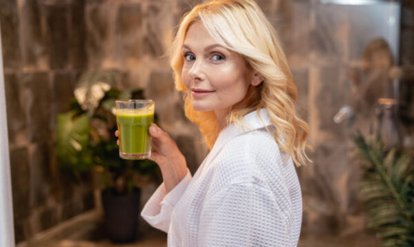 caucasian woman with a healthy vegetable drink