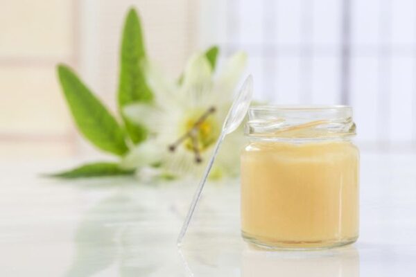 raw organic royal jelly in a small bottle with passiflora